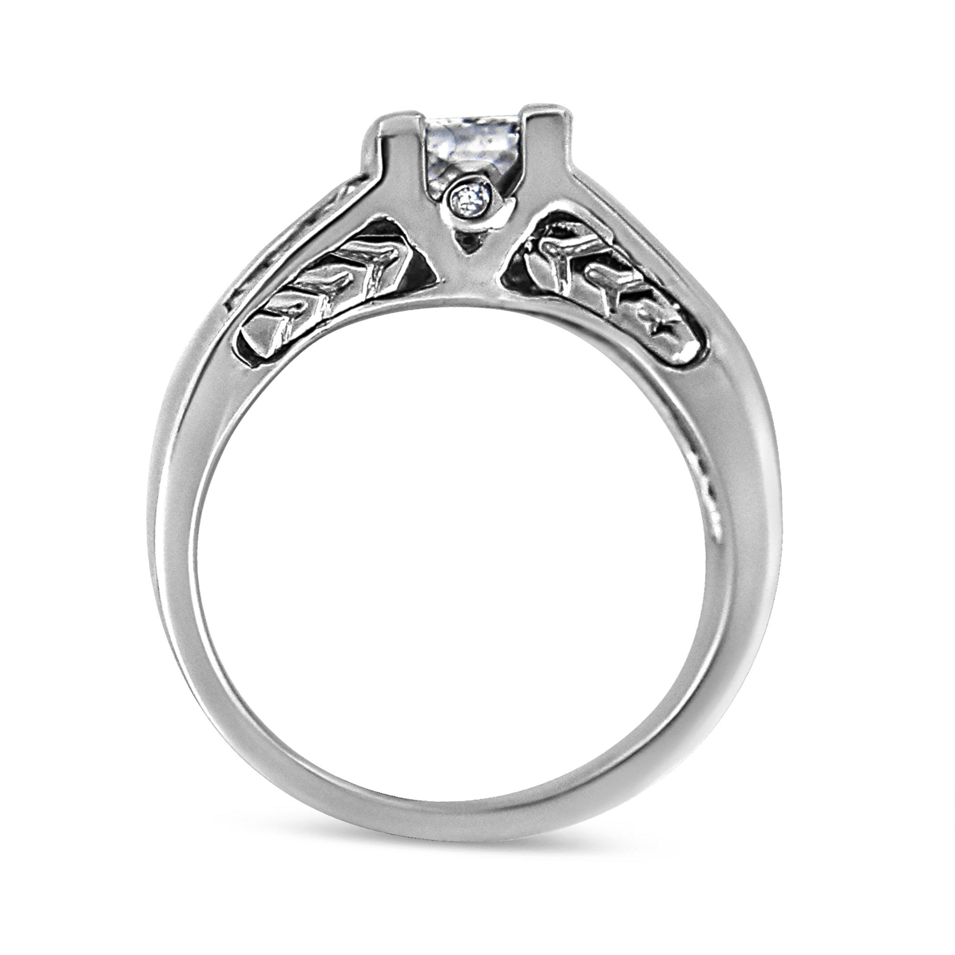 White metal ring shown from the side with two round bezel-set white gemstones and multiple princess-shaped white gemstones in channel and invisible settings.