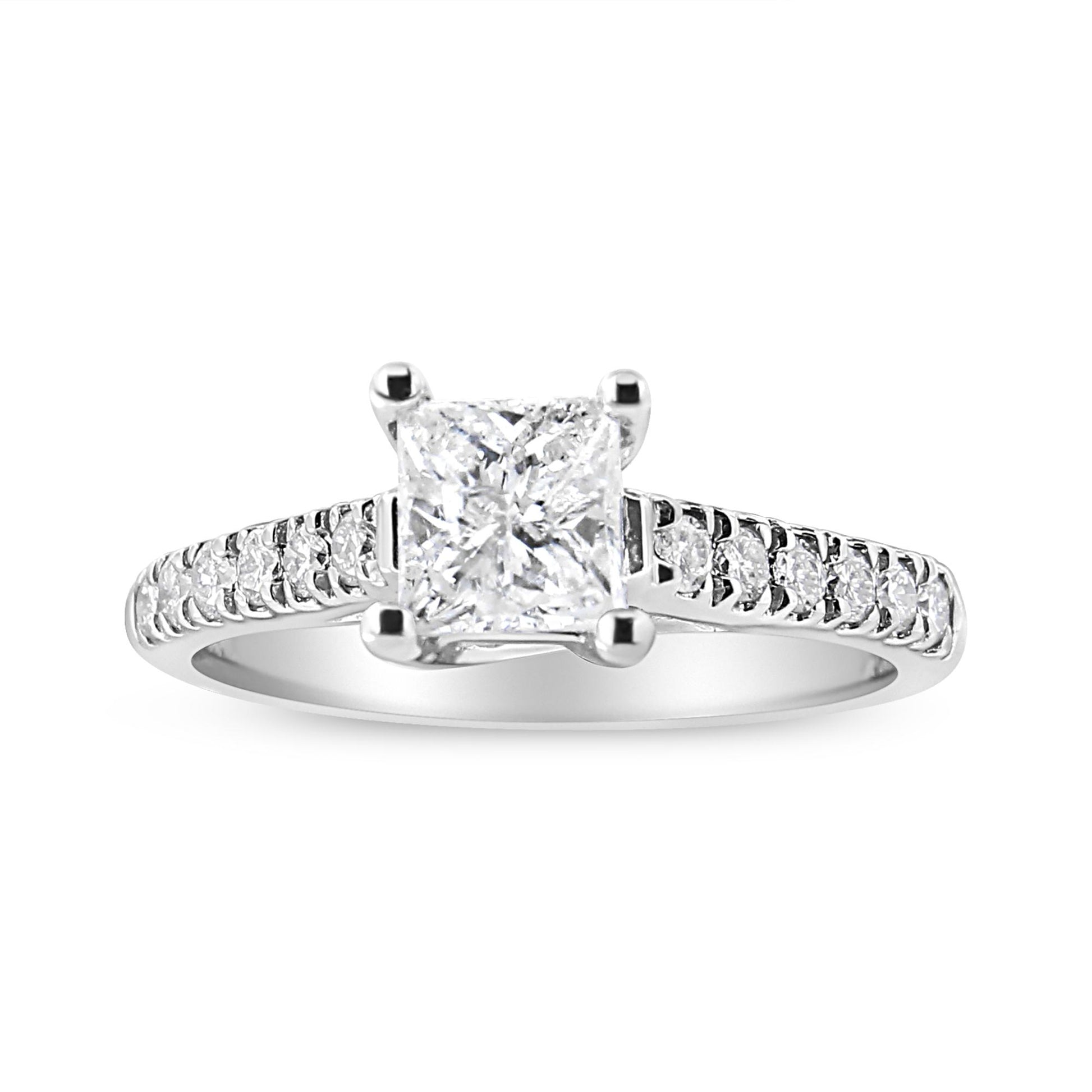 Front angled view of a white ring featuring a princess-shaped white gemstone in a four-prong setting, flanked by multiple round white gemstones along the band.