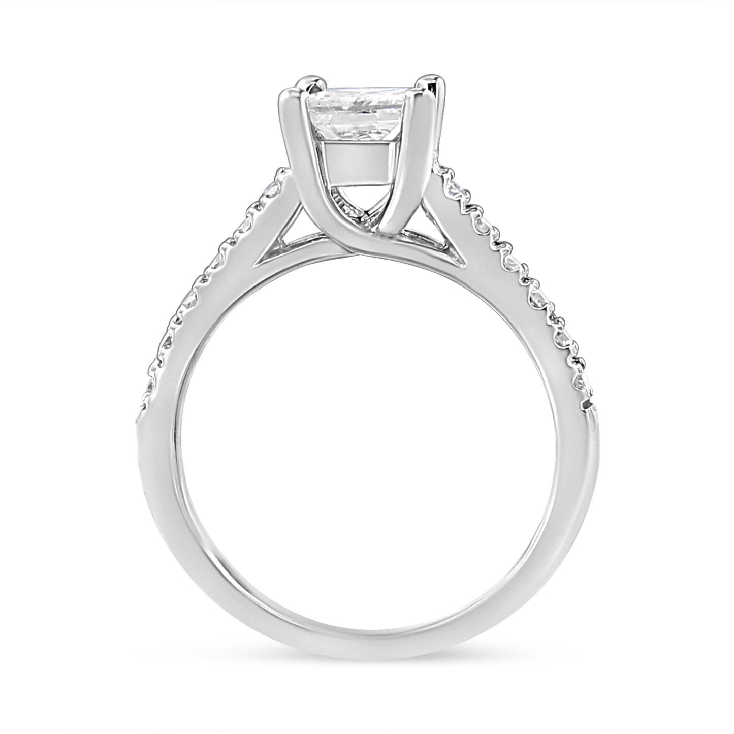 White metal ring shown from side angle with a princess-shaped white gemstone in a four-prong setting and round white gemstones along the band.