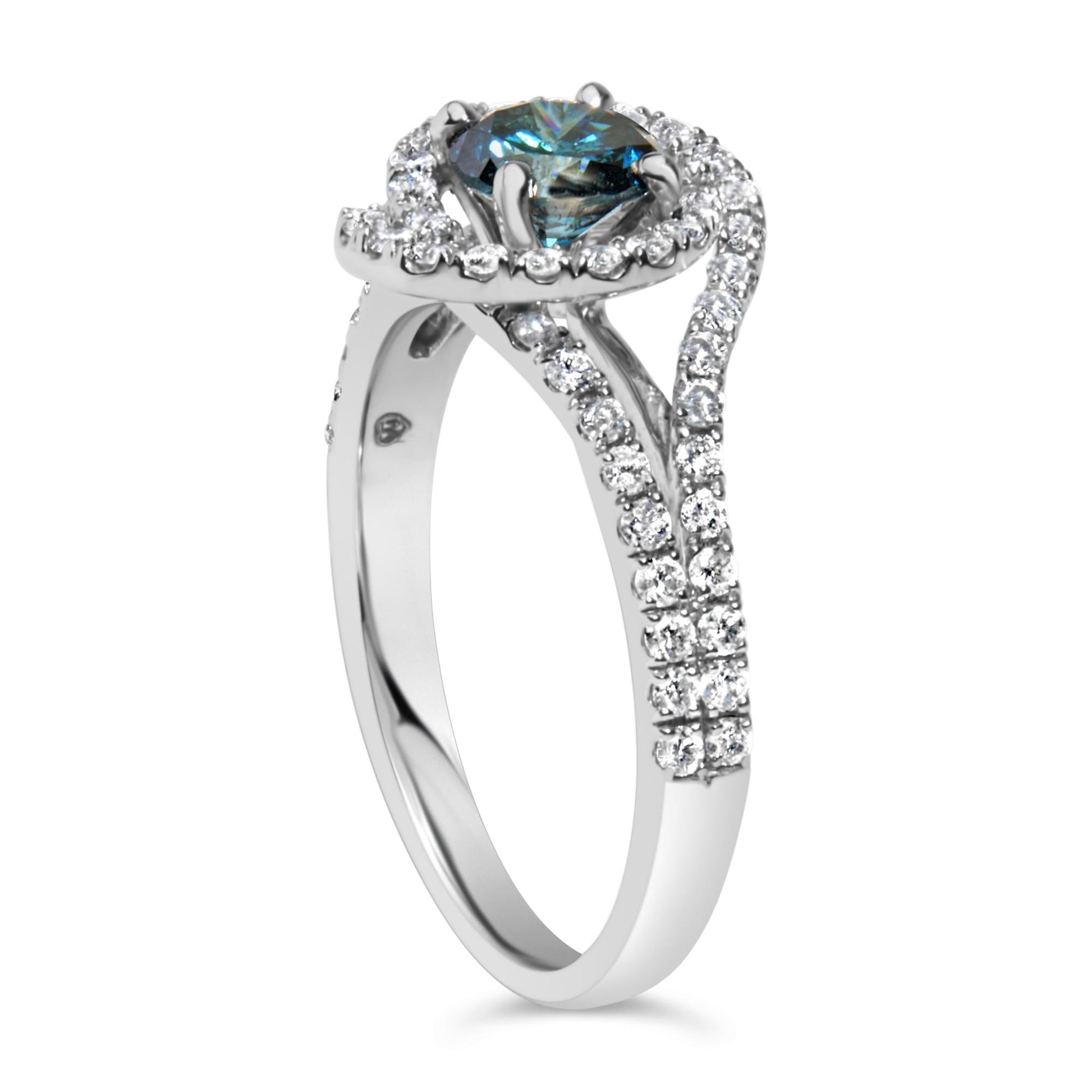 White metal ring shown at a slight angle featuring a round blue gemstone in a prong setting surrounded and accented by multiple round white gemstones in prong settings.