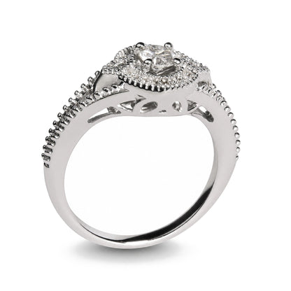 Close-up side angle of a white metal ring featuring a central round white gemstone in a prong setting, surrounded by smaller round white gemstones also in prong settings along the band and around the centerpiece. The band includes decorative cut-out details.