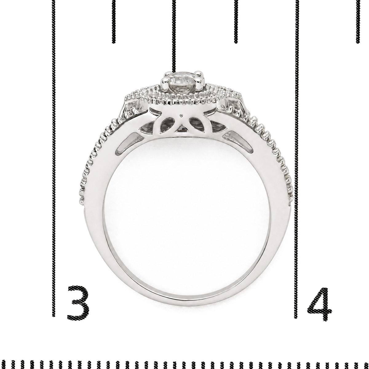 Close-up front view of a white metal ring shown on a scale, featuring a single round white gemstone in prong setting at the center and a halo of smaller round white gemstones surrounding it.
