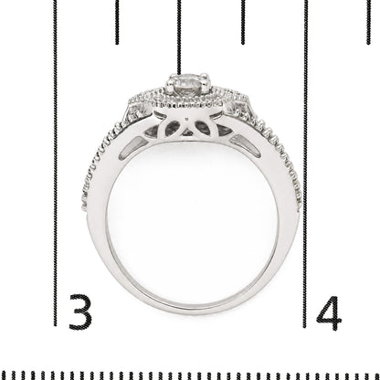 Close-up front view of a white metal ring shown on a scale, featuring a single round white gemstone in prong setting at the center and a halo of smaller round white gemstones surrounding it.