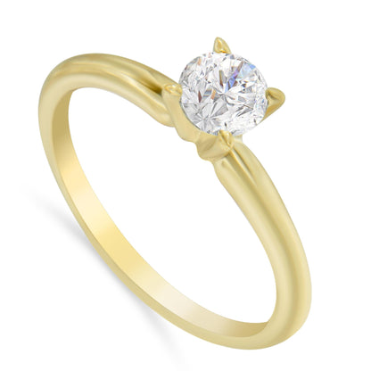 Yellow metal ring with a round white gemstone in a prong setting, viewed at an angle.