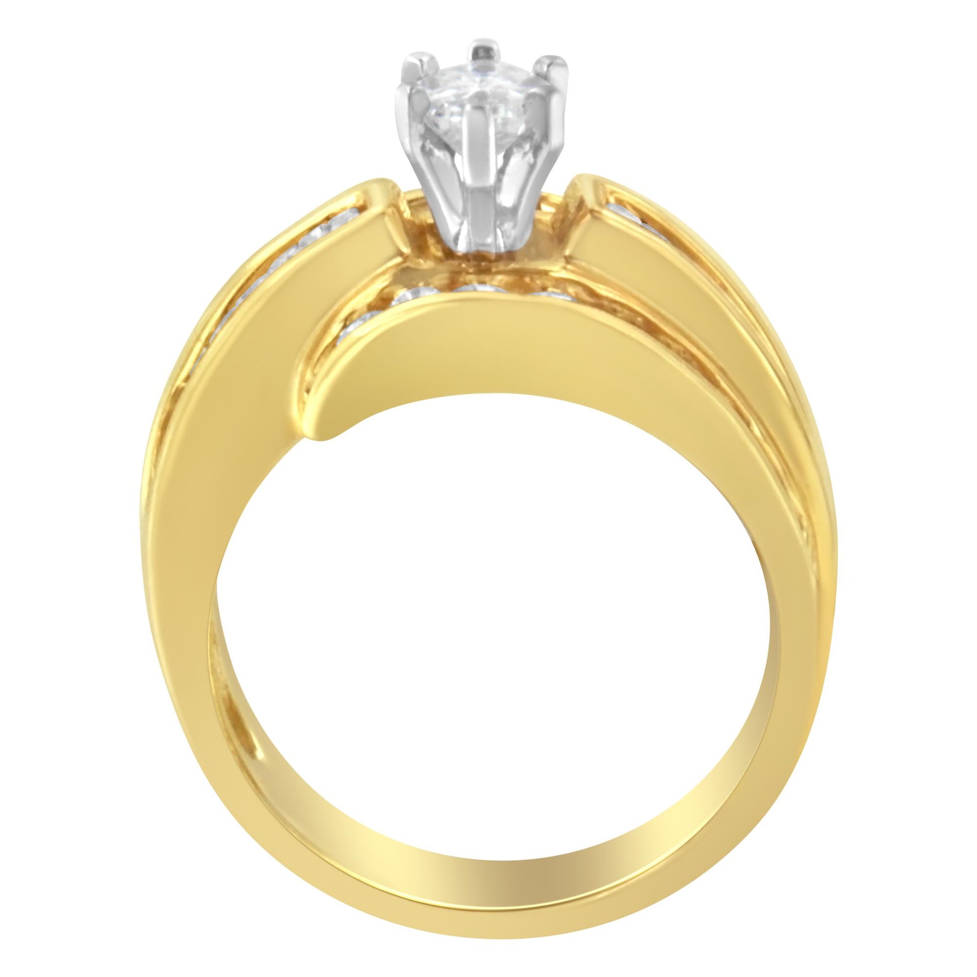 Front view of a yellow and white metal ring featuring a prong-set pie-shaped white gemstone at the center and channel-set baguette and round white gemstones along the band.