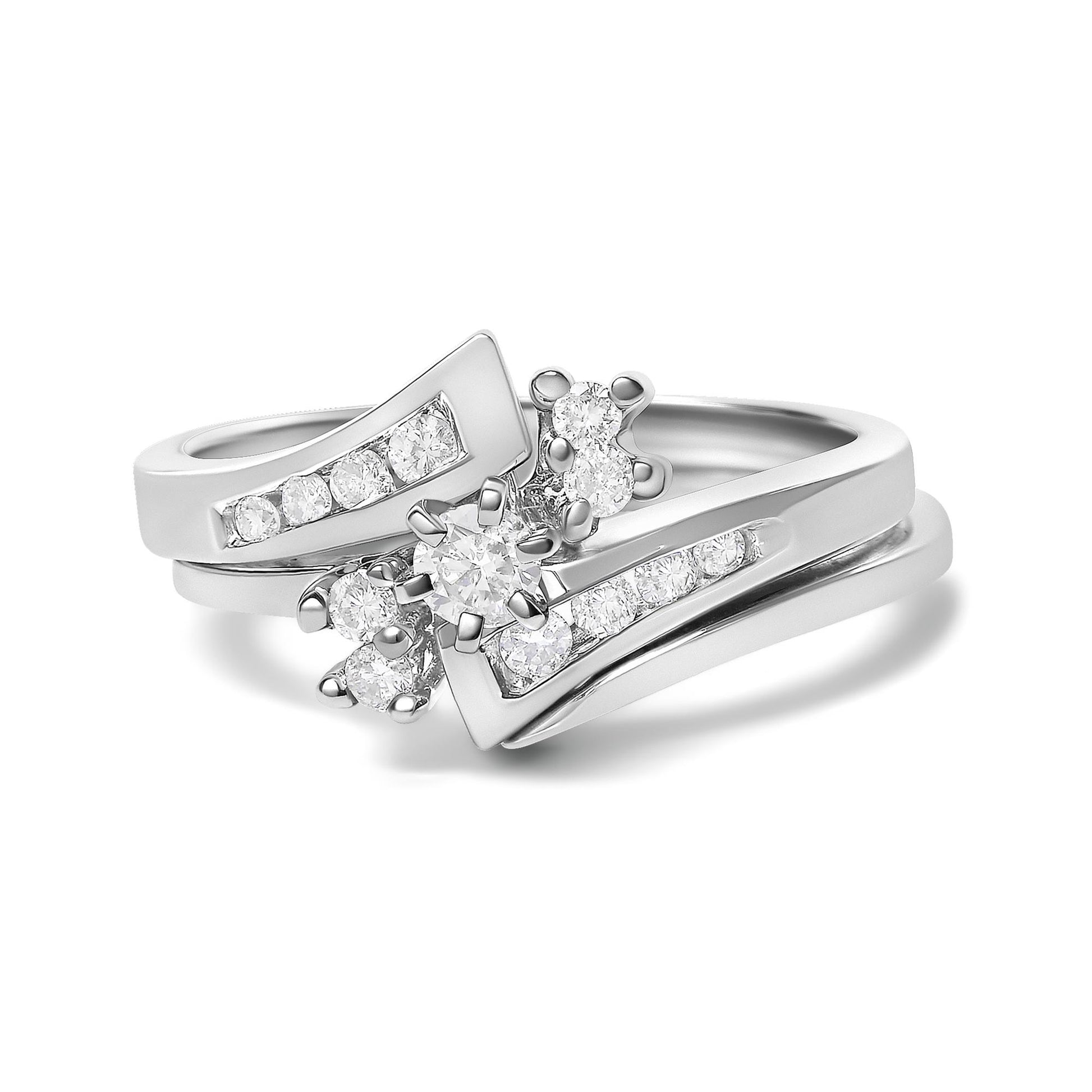 Close-up front angle of a white color ring featuring multiple round white gemstones in prong settings arranged in a decorative design.