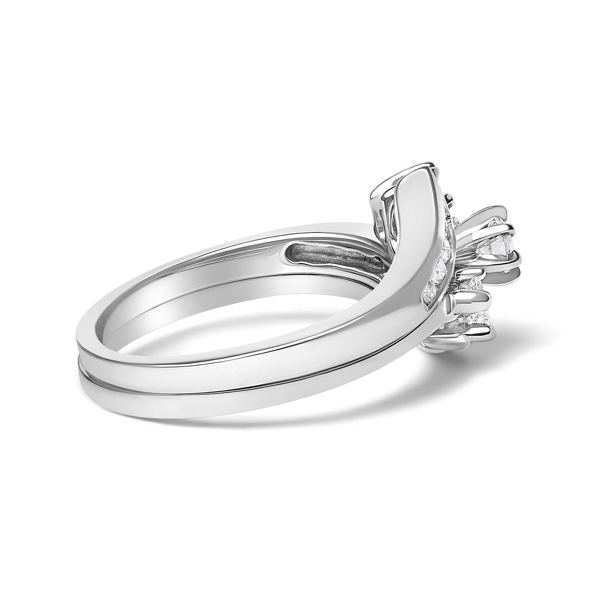 Close-up side angle of a white metal ring with two bands, featuring a decorative top with multiple round white gemstones in prong settings.