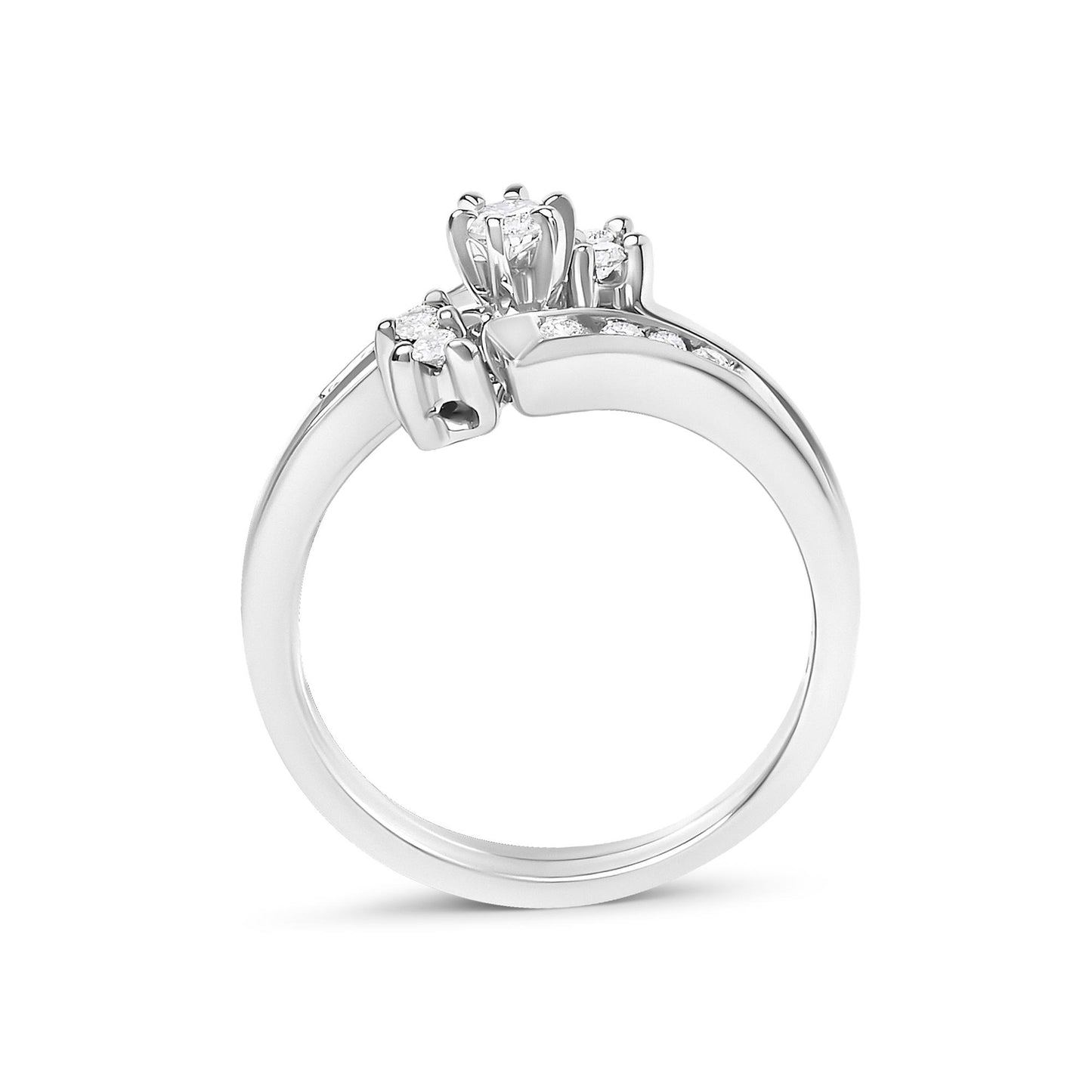 Close-up front angled view of a white metal ring featuring multiple round white gemstones in prong settings along the band and cluster at the center.