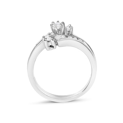 Close-up front angled view of a white metal ring featuring multiple round white gemstones in prong settings along the band and cluster at the center.