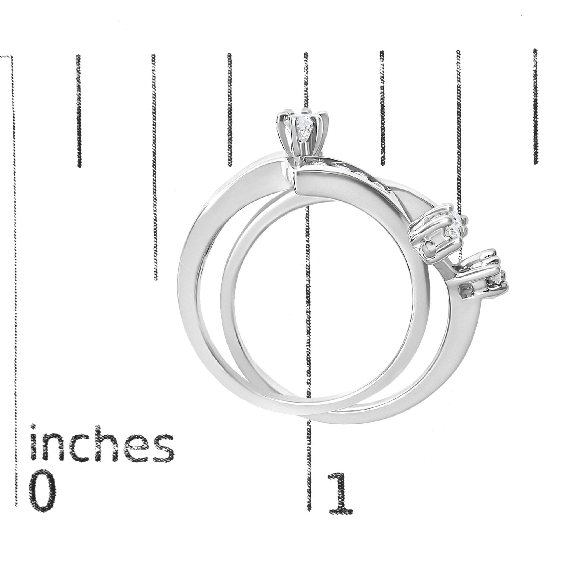 Close-up image of white metal ring shown on a scale from a side angle, featuring round white gemstones in prong settings.