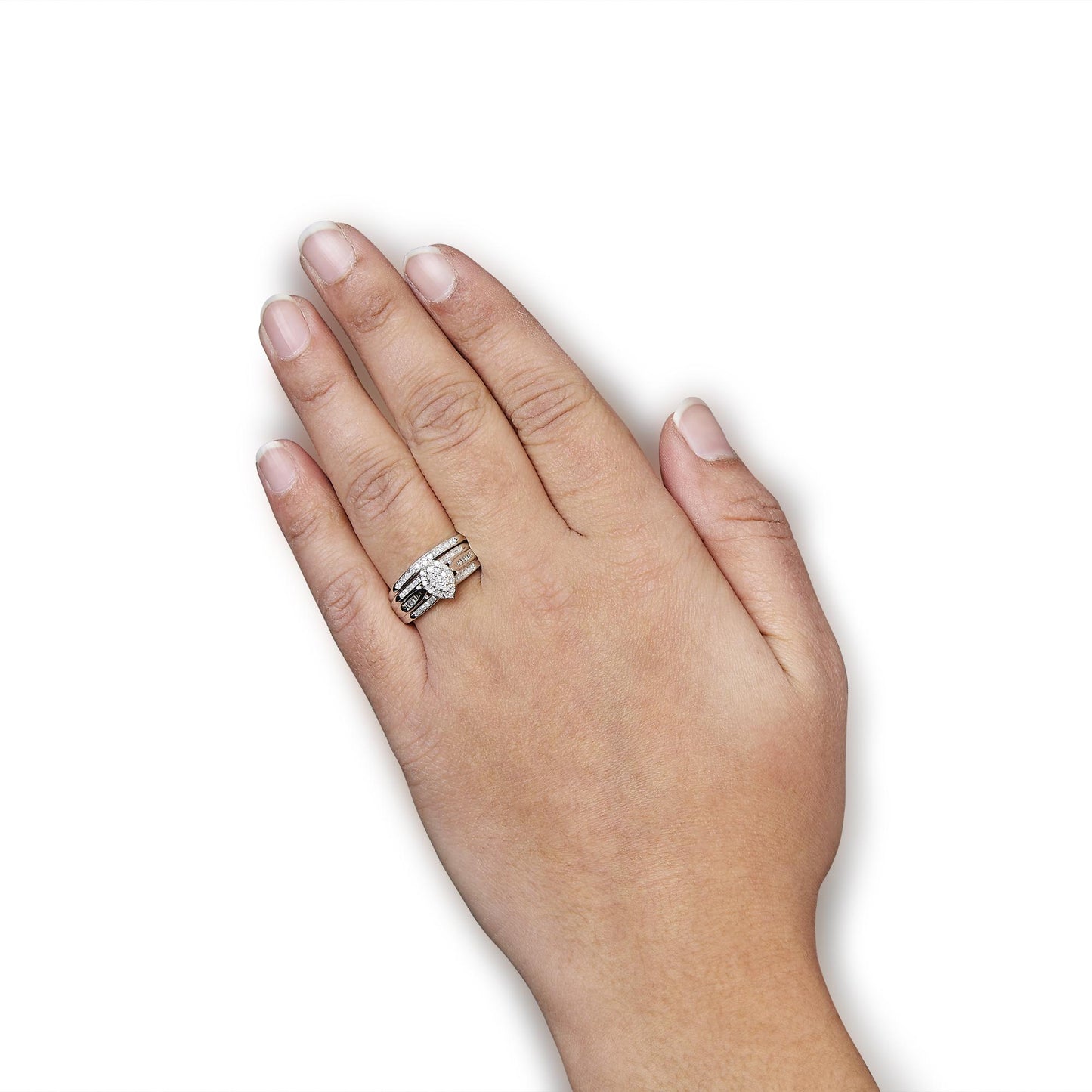 Top view of a white metal ring with round prong-set white gemstones and baguette channel-set white gemstones, worn on a model's finger.
