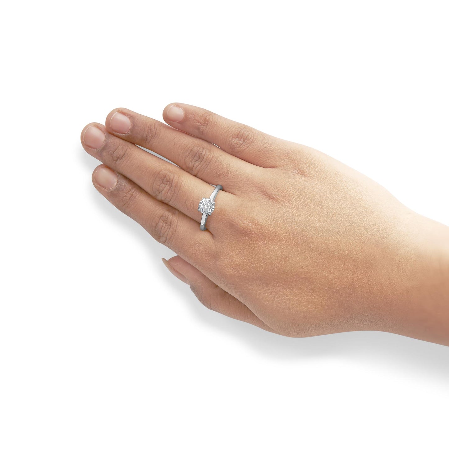 Close-up angled shot of a white metal ring with a single round white gemstone in a 4-prong setting on a model's hand.