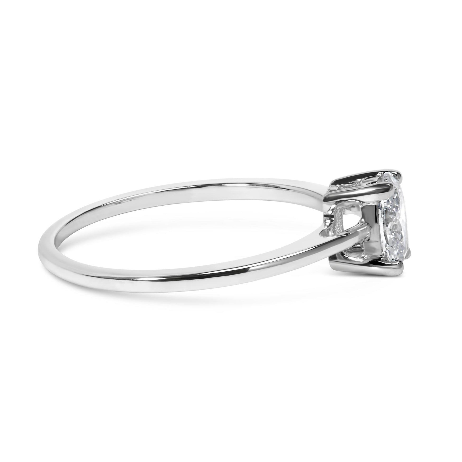 Side view of a white metal ring featuring a single oval-shaped white gemstone in a four-prong setting.
