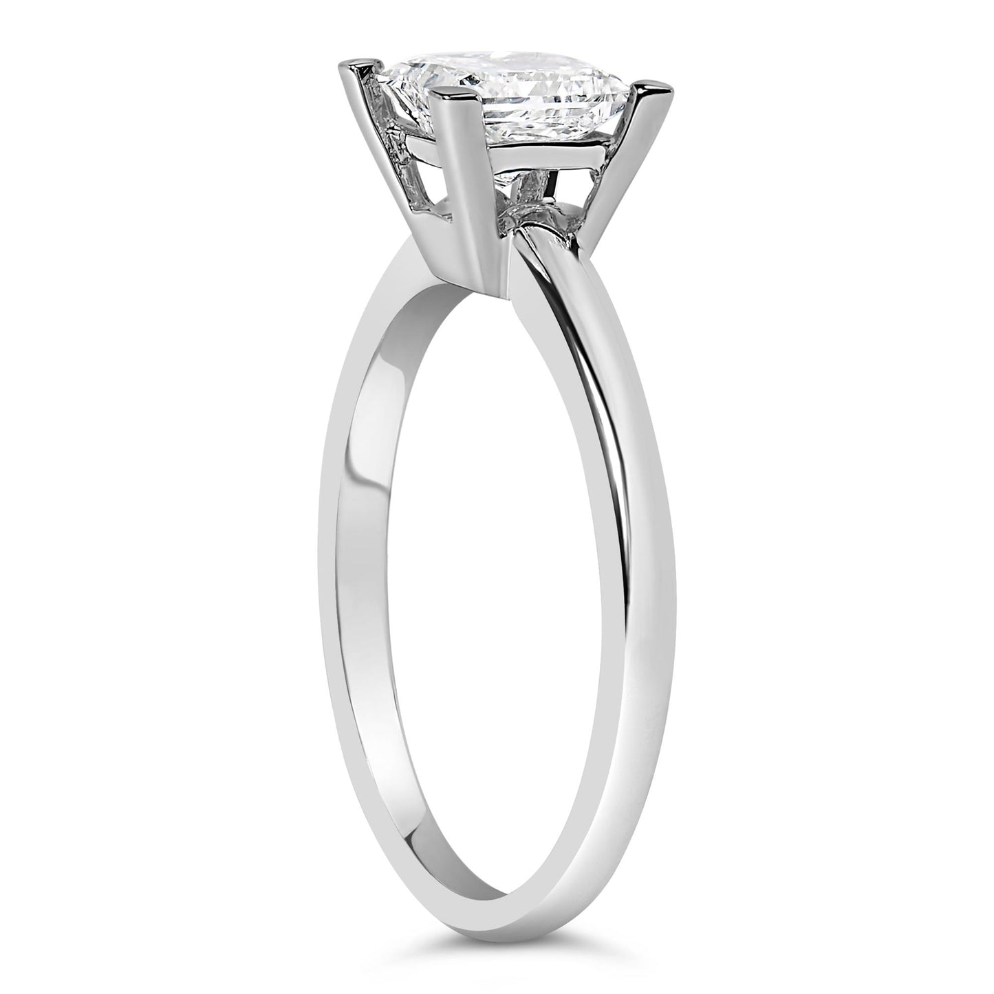 Side angle view of a white metal ring with a single white princess-shaped gemstone in prong setting.