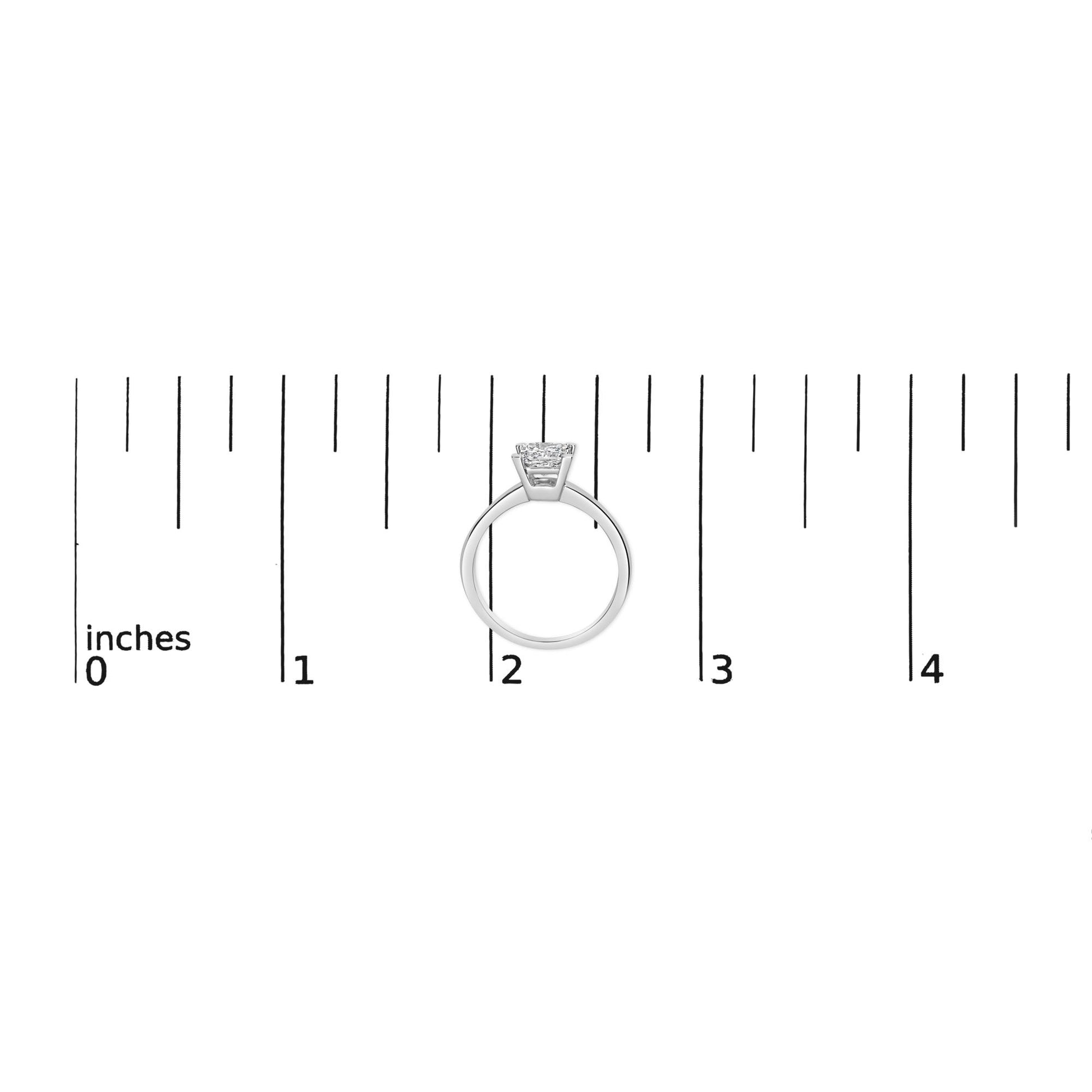 White metal ring with a princess-shaped white gemstone in a prong setting, shown from the side on a ruler for size reference.