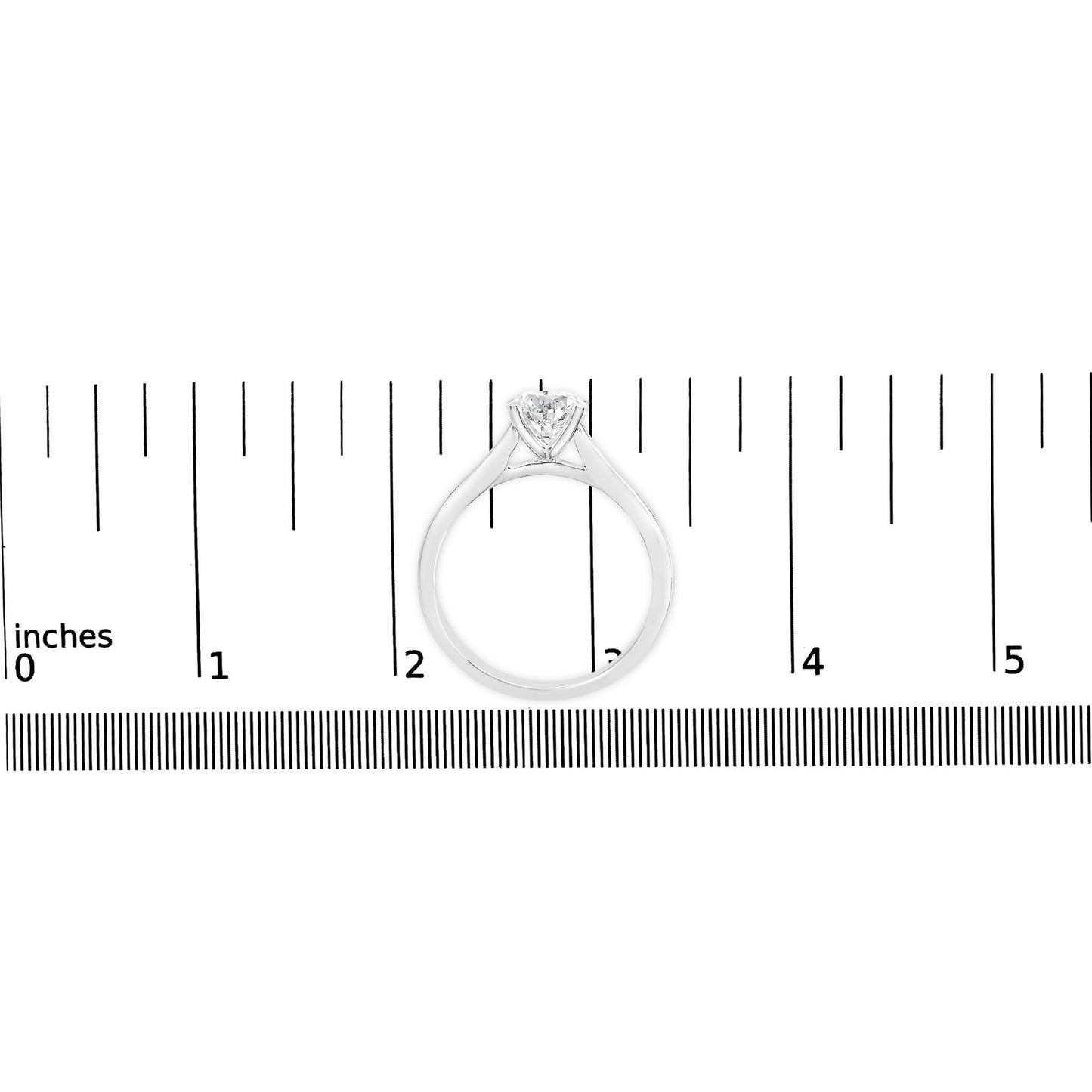 White metal ring with a round white gemstone in a four-prong setting, shown from the front on a ruler for size reference.