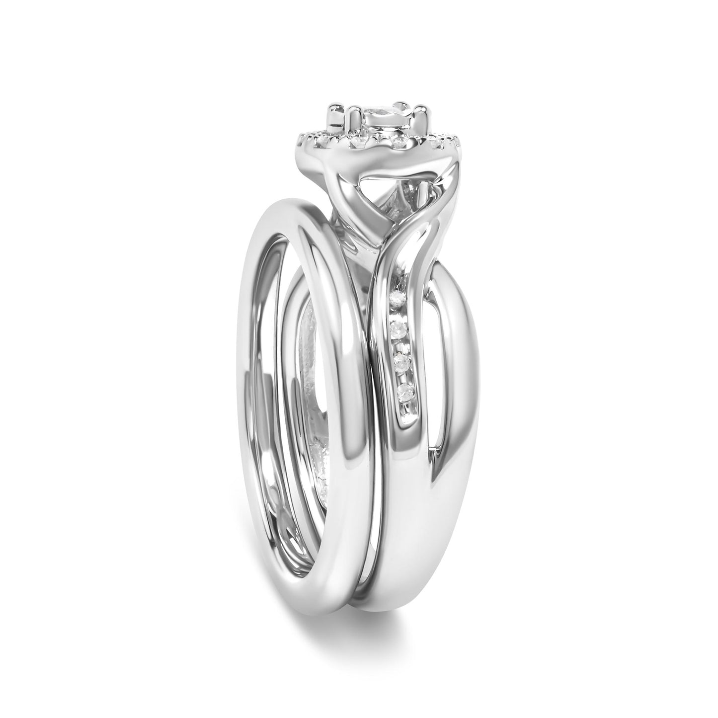 Close-up front angle of a white metal ring featuring a central prong-set round white gemstone surrounded by multiple smaller prong-set round white gemstones along the band.