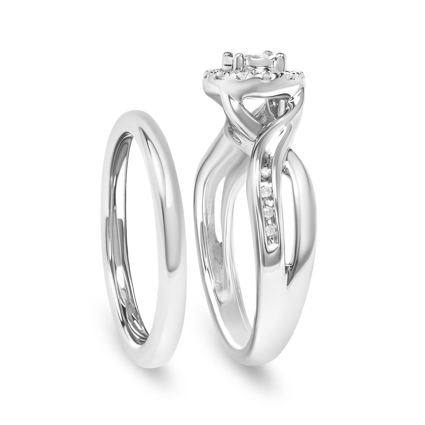 Front angle view of two white metal rings, one plain band and one with a twisting design featuring prong-set round white gemstones along the band and a larger gemstone at the center.