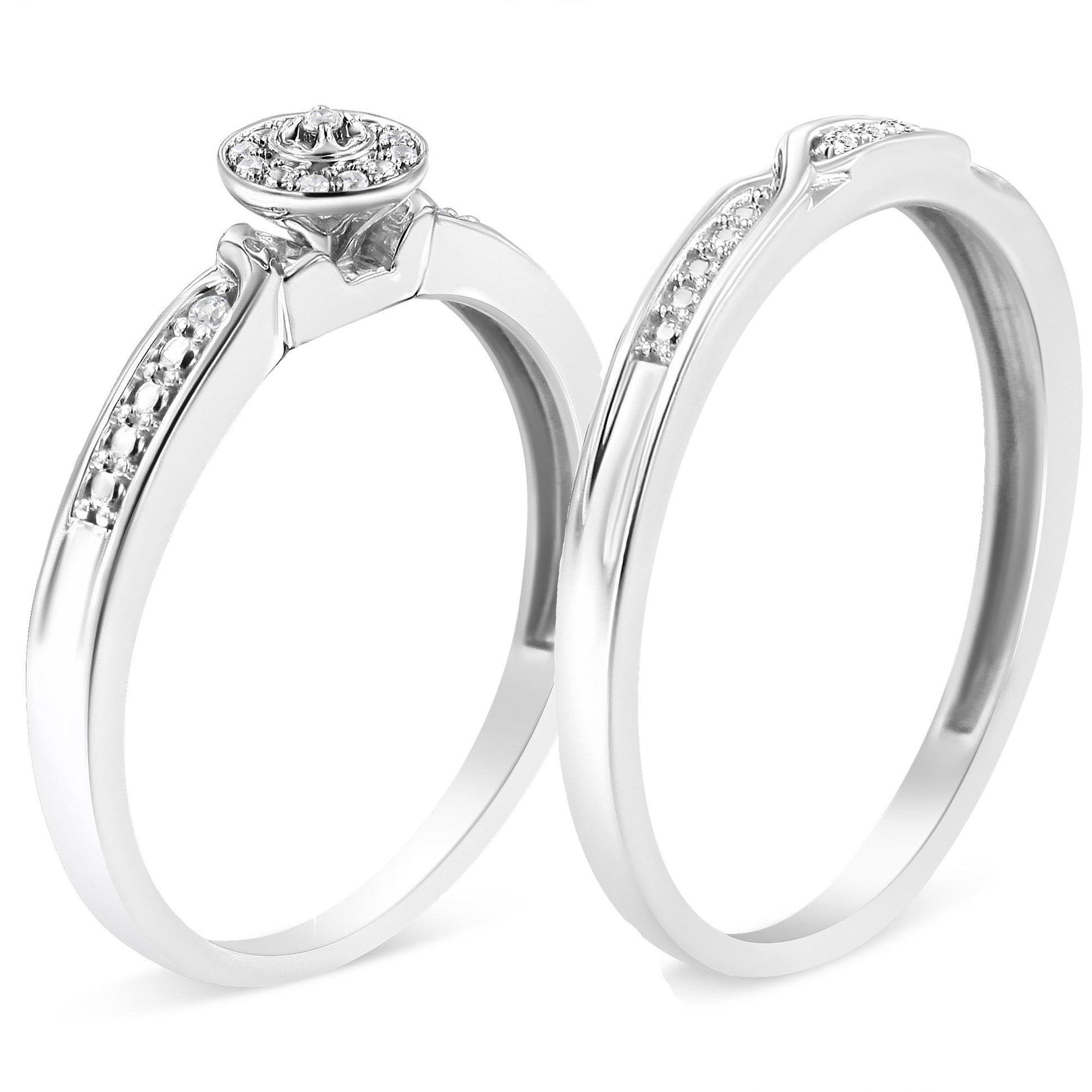 Two white metal rings with round white gemstones in prong settings, shown from a front angle.