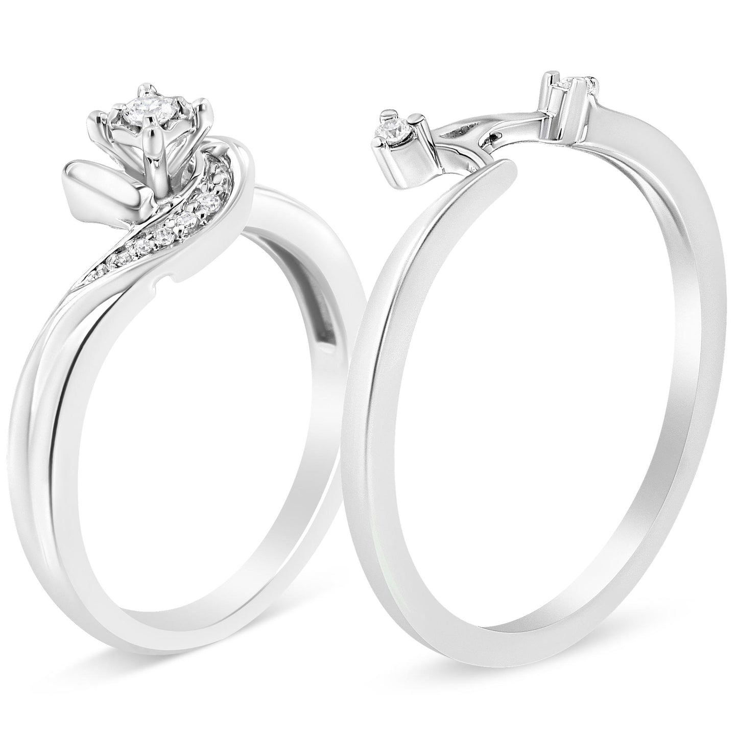 Two white metal rings shown at an angled front view, one with a prominent prong-set round white gemstone and a curved row of smaller white gemstones along the band, the other ring with a plain band and a small round white gemstone on the prong setting.