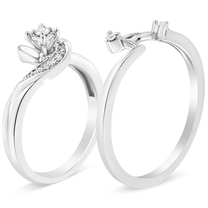 Two white metal rings shown at an angled front view, one with a prominent prong-set round white gemstone and a curved row of smaller white gemstones along the band, the other ring with a plain band and a small round white gemstone on the prong setting.