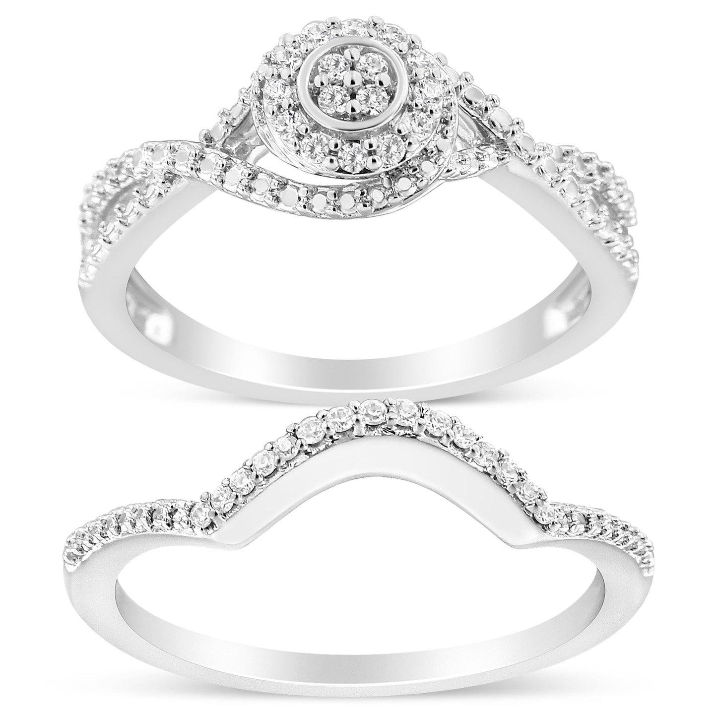 Top view of two white metal rings; the upper ring features multiple small round white gemstones in a layered circular cluster and along the band, the lower ring has a curved shape with small round white gemstones along the top half.