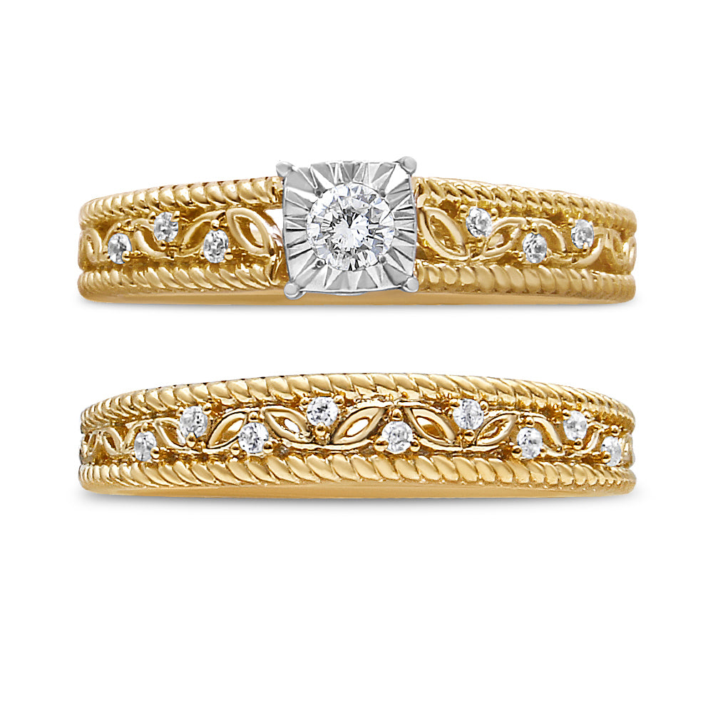Front-facing close-up of two yellow rings, each with round white gemstones in prong settings and decorative leaf-like designs along the bands.