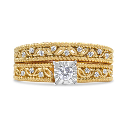Close-up front view of a yellow metal ring with a central round white gemstone set in a prong setting on a square-shaped mount, flanked by intricate vine and leaf patterns accented with smaller round white gemstones in prong settings.