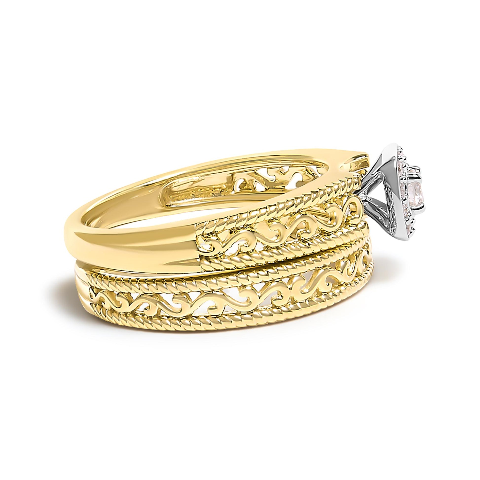 Yellow metal ring with intricate openwork design, featuring a raised white gemstone in a prong setting visible from a side angle.