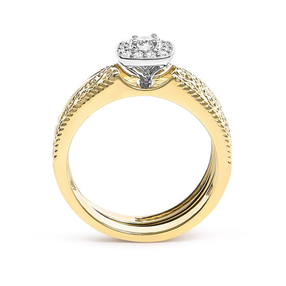 Yellow metal ring with one center round white gemstone in a four-prong setting, surrounded by multiple smaller round white gemstones in prong settings, shown from a side angle.
