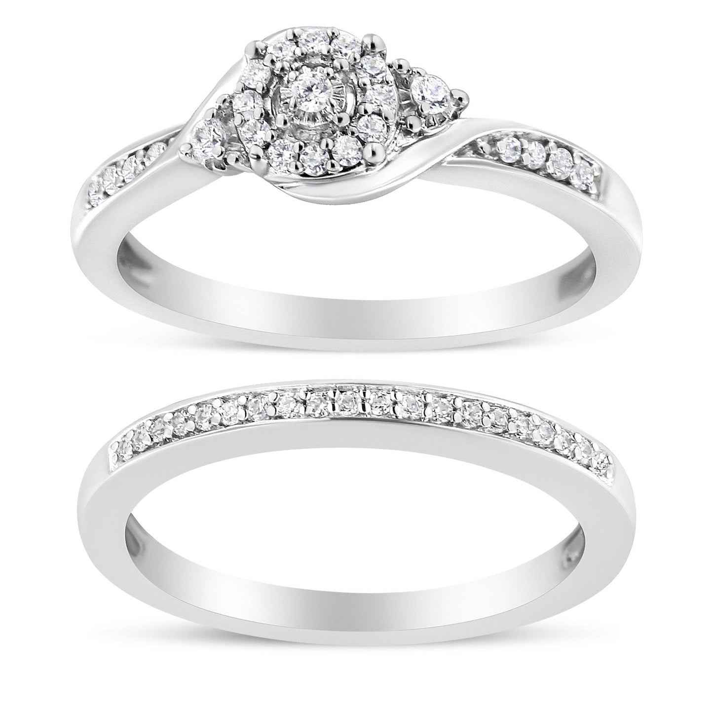 Top view of two white metal rings with round white gemstones in prong settings; the upper ring features a cluster center design and side gemstones, while the lower ring has a row of gemstones along the band.