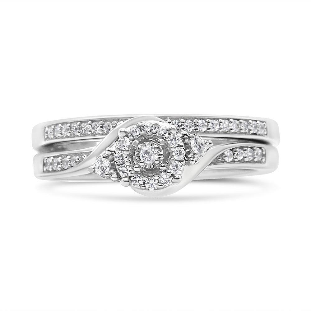 Front view of a white metal ring set featuring multiple round white gemstones in prong settings, including a central cluster design and two bands adorned with smaller round gemstones.