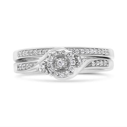 Front view of a white metal ring set featuring multiple round white gemstones in prong settings, including a central cluster design and two bands adorned with smaller round gemstones.