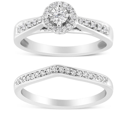 Two white metal rings shown from a front angle; the top ring features a central round white gemstone surrounded by smaller white gemstones with additional white gemstones along the band, and the bottom ring has a V-shaped design with white gemstones along the top.