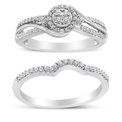 Two white metal rings with round white gemstones in prong settings, shown from the front angle. The top ring features a cluster of gemstones in a central circular design with split shank bands adorned with gemstones. The bottom ring has a contoured shape with a single row of gemstones along the top.