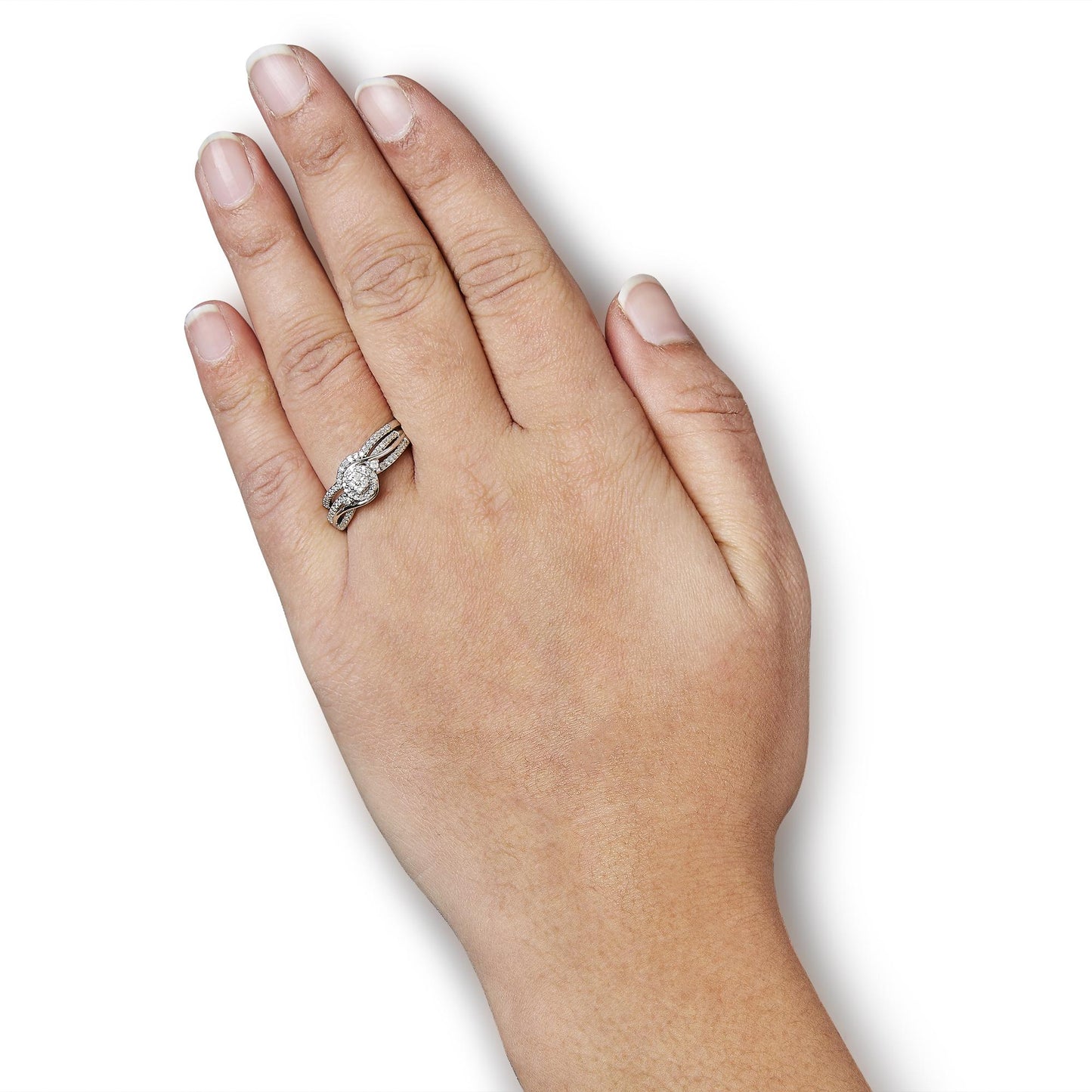 White metal ring with multiple rows of small round white gemstones and a cluster of round white gemstones at the center, worn on a model's hand, shown from a top angle.