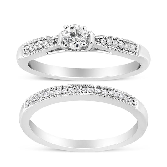 Two white metal rings shown from a front angle; one features a central round white gemstone in a four-prong setting with additional small round white gemstones set along the band, the other is a full eternity style ring with small round white gemstones in a shared prong setting along the band.