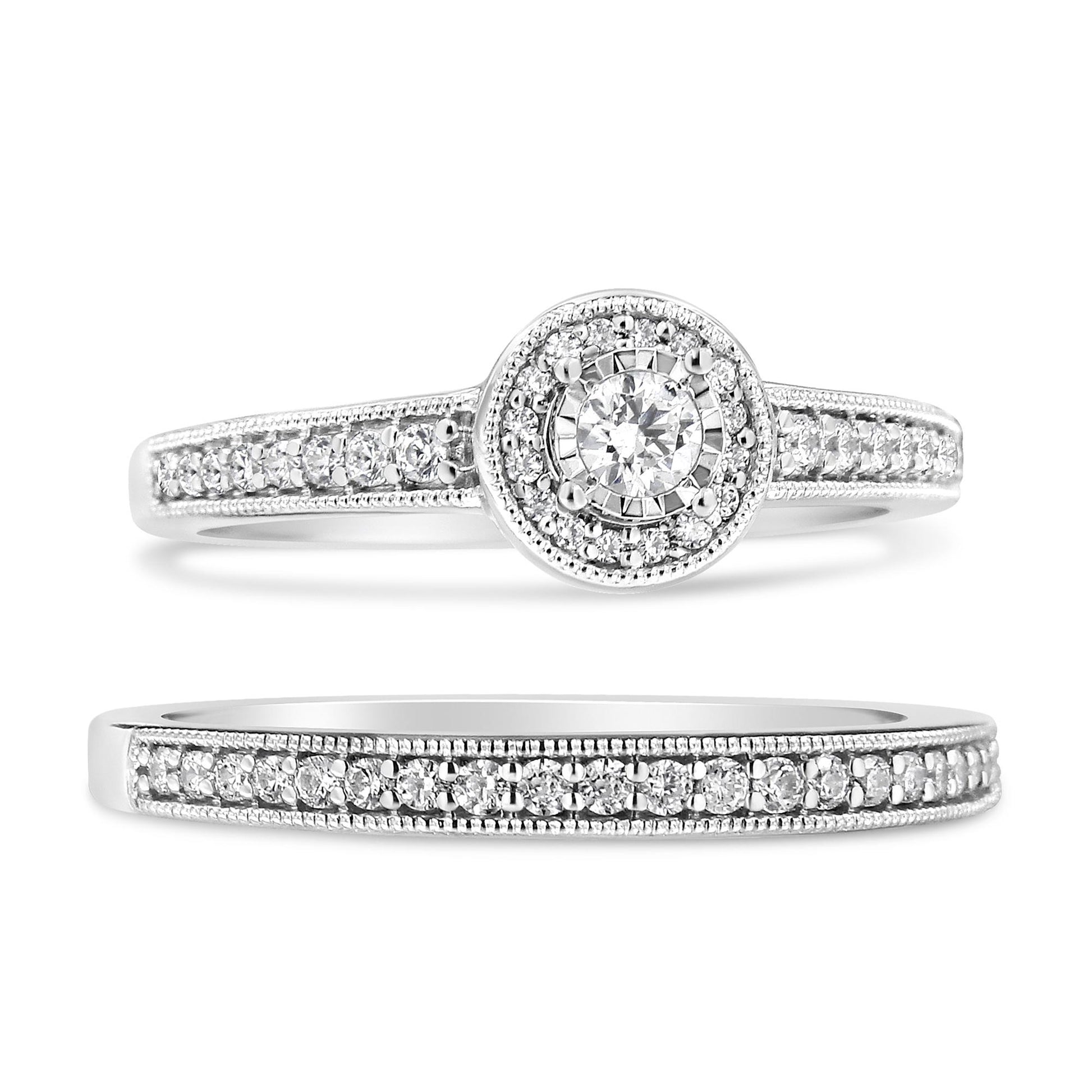 Close-up front angle of two white metal rings, one featuring a central round white gemstone in a miracle setting surrounded by smaller white gemstones in pave settings along the band, and the other ring with a band fully adorned with white gemstones in pave settings.