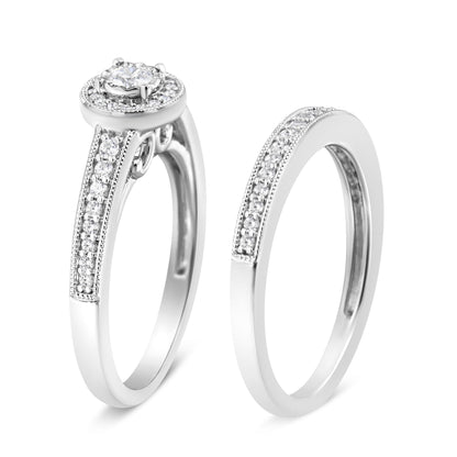 Two white metal rings shown at a slight angle, one with a central round white gemstone in a raised setting surrounded by smaller white gemstones on the band, the other ring featuring a row of small white gemstones set in a pave style on the band.