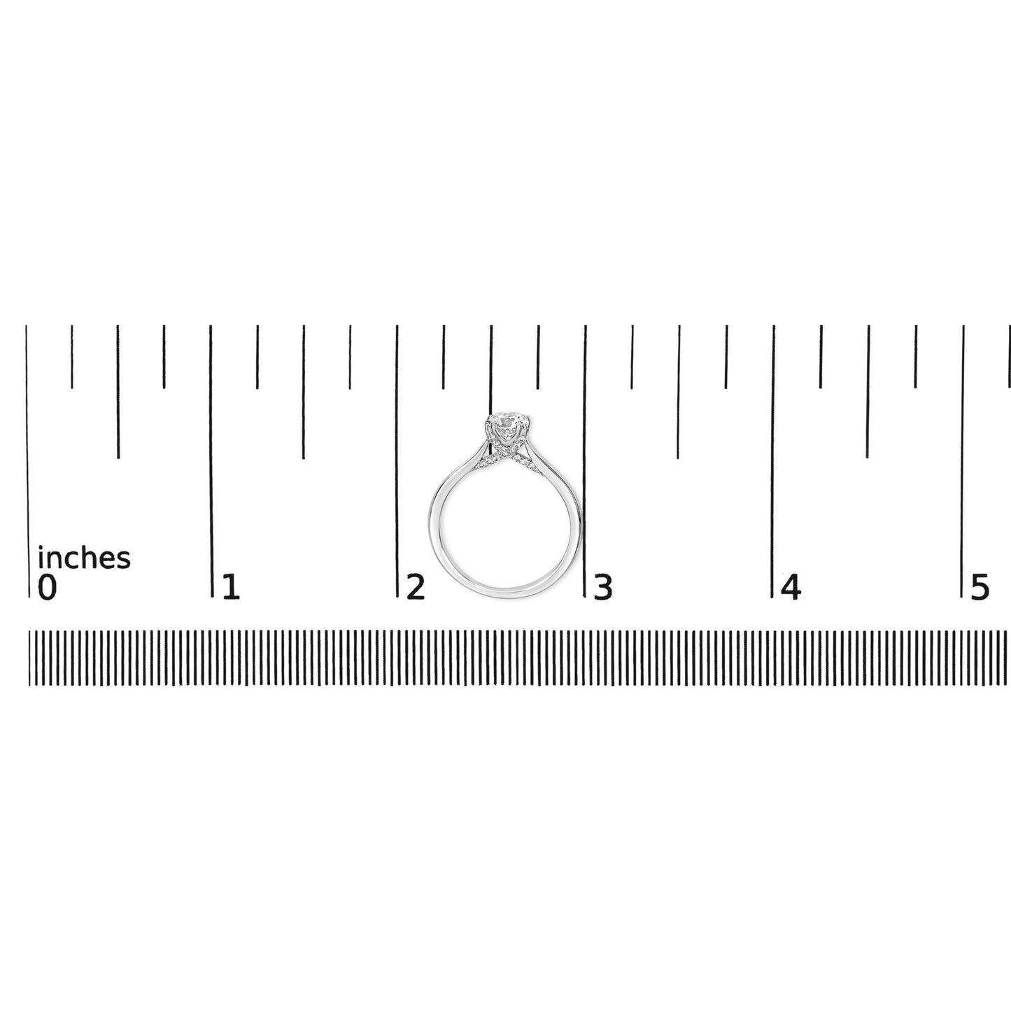 White metal ring with a single round white gemstone in a four-prong setting and multiple smaller round white gemstones in prong settings, shown from the side on a ruler for size reference.