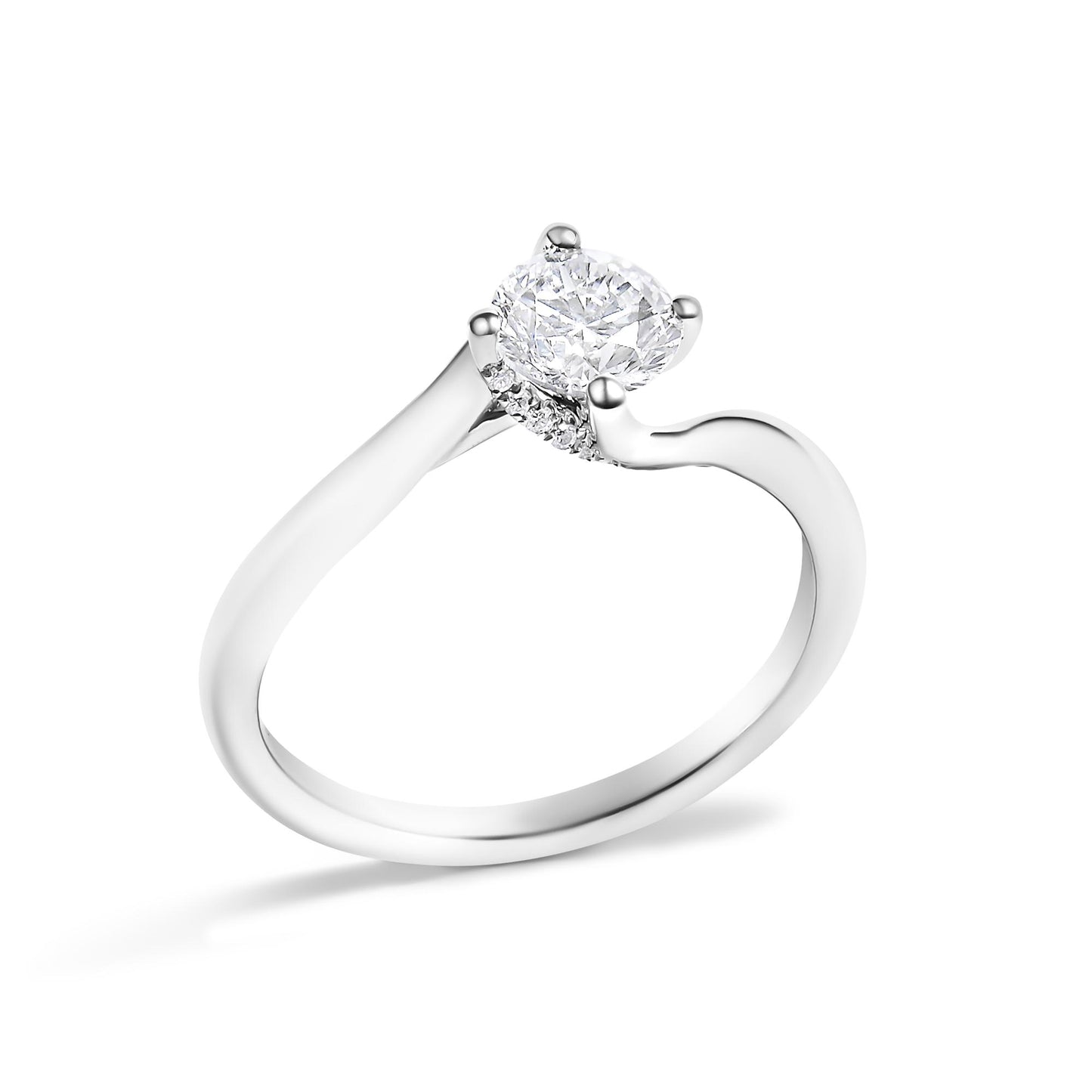 White metal ring with a round center white gemstone in a four-prong setting and surrounding smaller round white gemstones, shown at a slight angle on a white background.