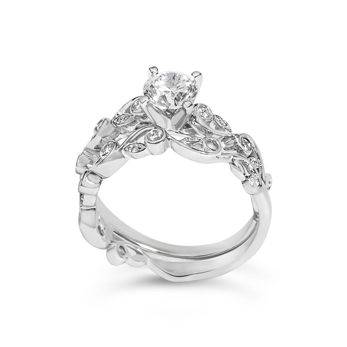 Close-up front angle of a white metal ring with a large round white gemstone in prong setting at the center and smaller round white gemstones set in intricate swirl designs along the band.