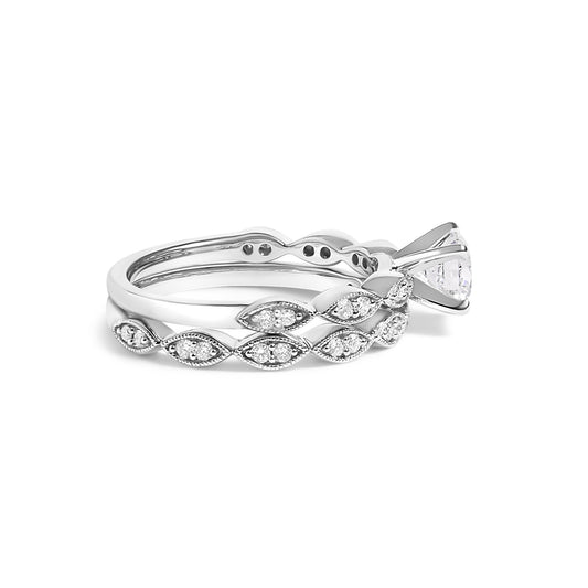 Side view of two white metal rings stacked together, one with a round white gemstone in prong setting and the other featuring a marquise pattern with small white gemstones in prong settings.