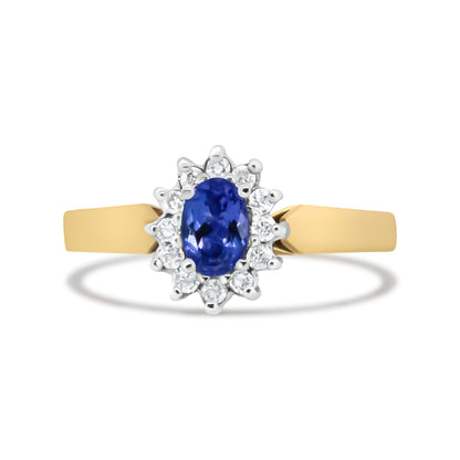 Front-facing view of a yellow metal ring with a central oval blue gemstone surrounded by round white gemstones in prong settings.