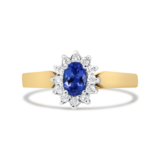 Front-facing view of a yellow metal ring with a central oval blue gemstone surrounded by round white gemstones in prong settings.