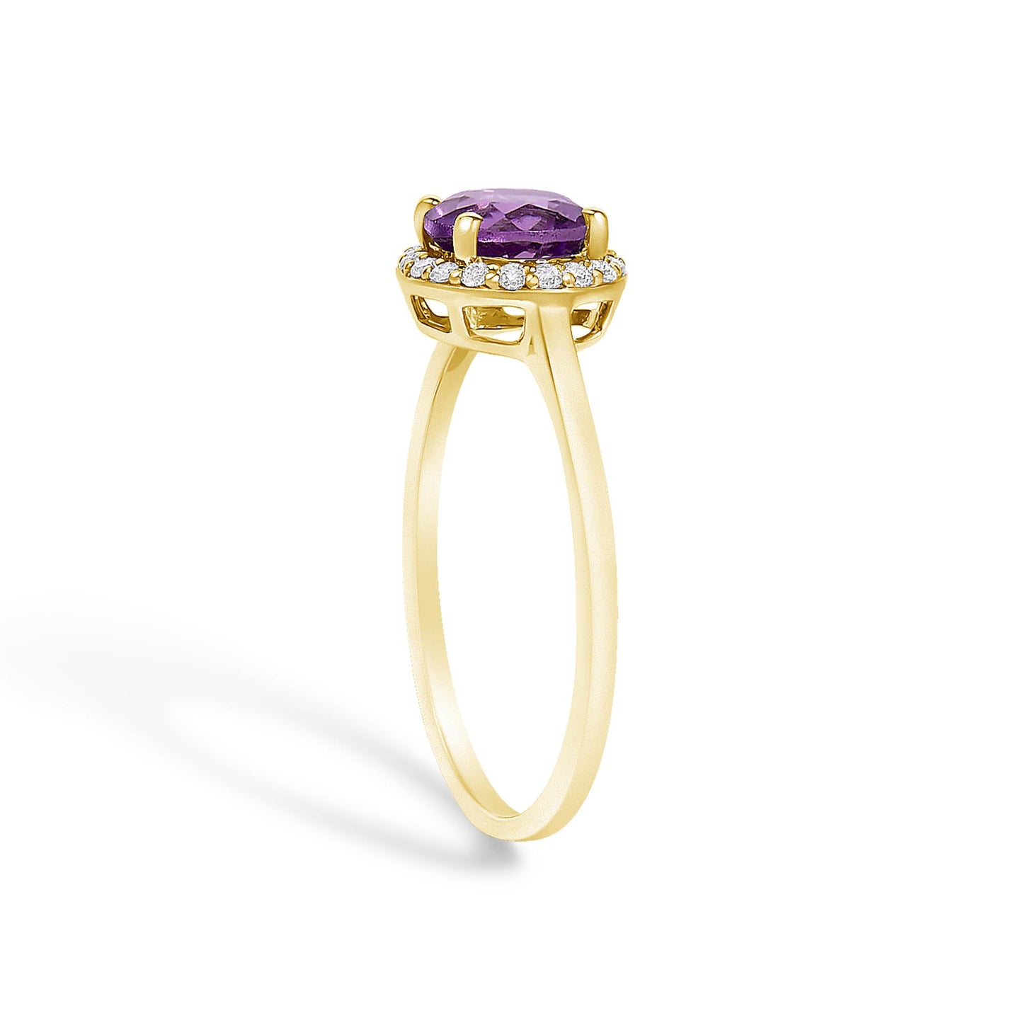 Side angle view of a yellow metal ring with a round purple gemstone held by four prongs, surrounded by a halo of round white gemstones in shared prong settings.