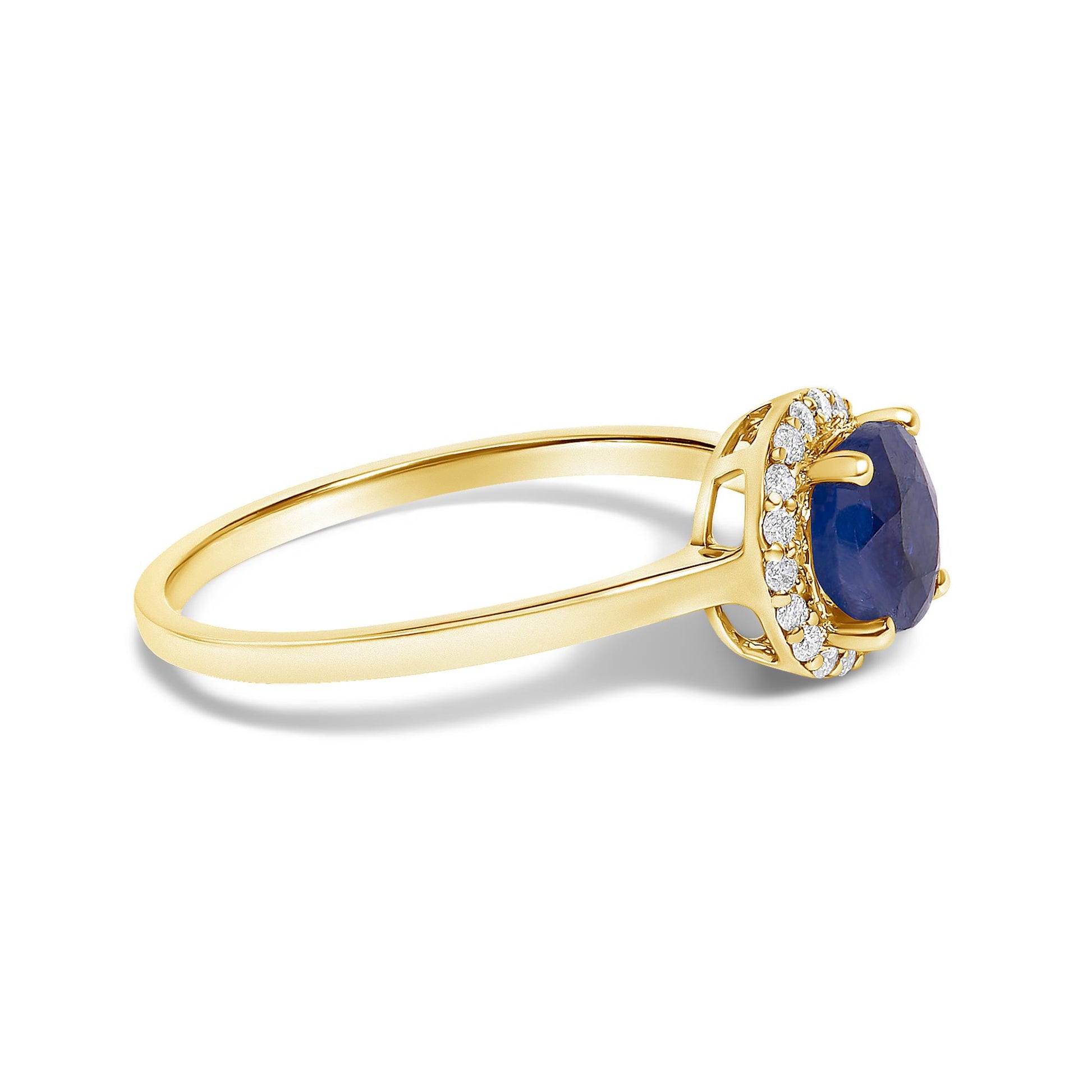 Yellow metal ring with a round blue gemstone in a four-prong setting, surrounded by multiple white gemstones in a shared prong setting, shown in a side angle on a white background.