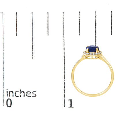 Yellow metal ring with a round blue gemstone center set in four prongs, surrounded by a halo of small white round gemstones in shared prong setting, shown on a scale from side angle.