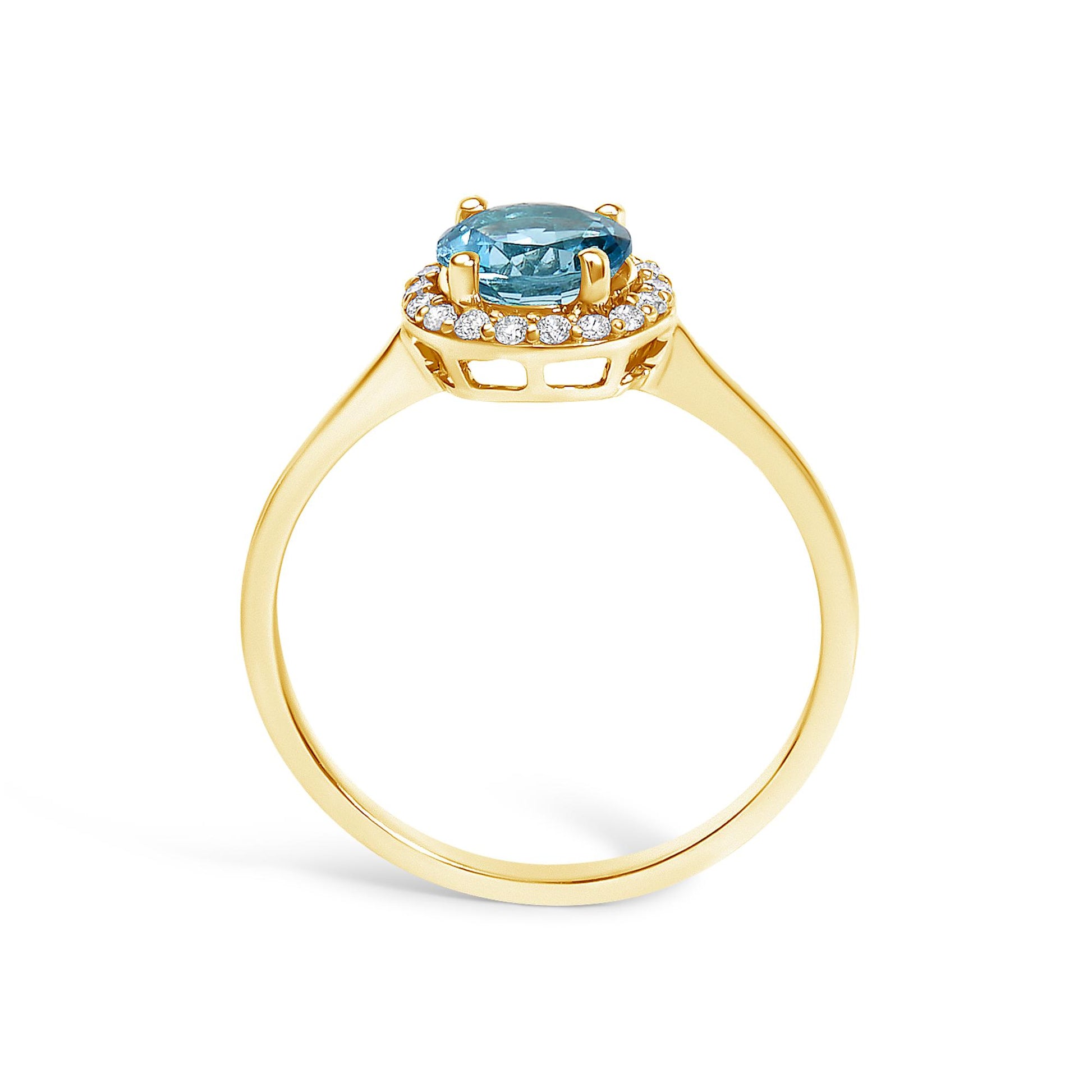 Ring with a yellow-colored band shown from the side angle, featuring a round blue gemstone in a four-prong setting surrounded by a halo of round white gemstones in a shared prong setting.