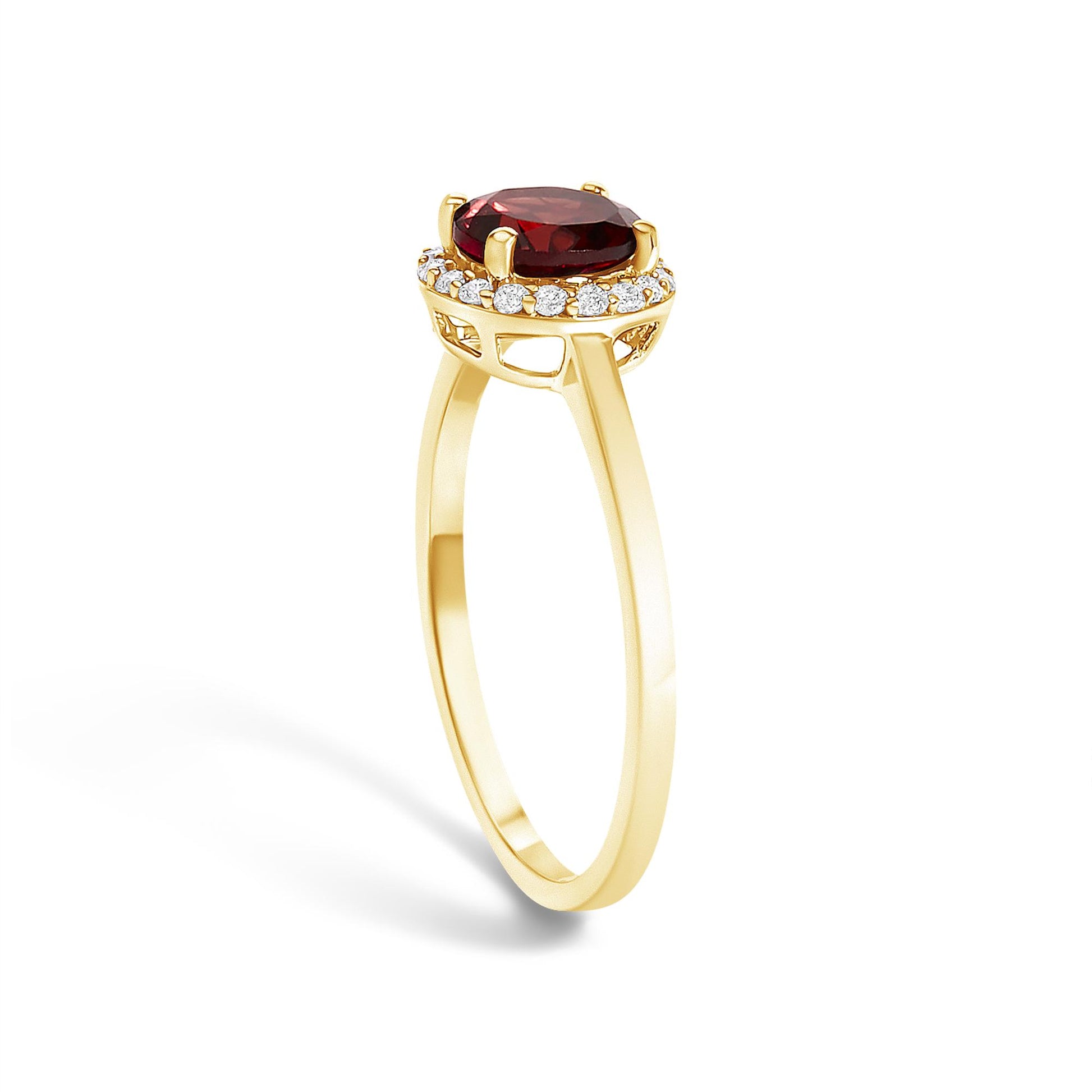 Yellow metal ring with a round red gemstone set in the center, surrounded by small round white gemstones in a shared prong setting, shown at a side angle.